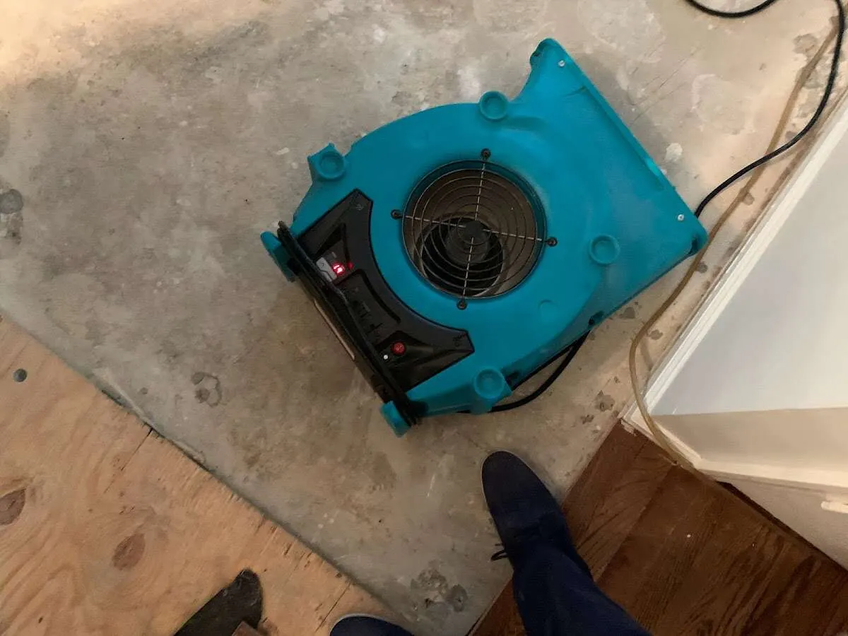 Air mover drying subfloor during Commercial Water Damage Restoration in Phelan
